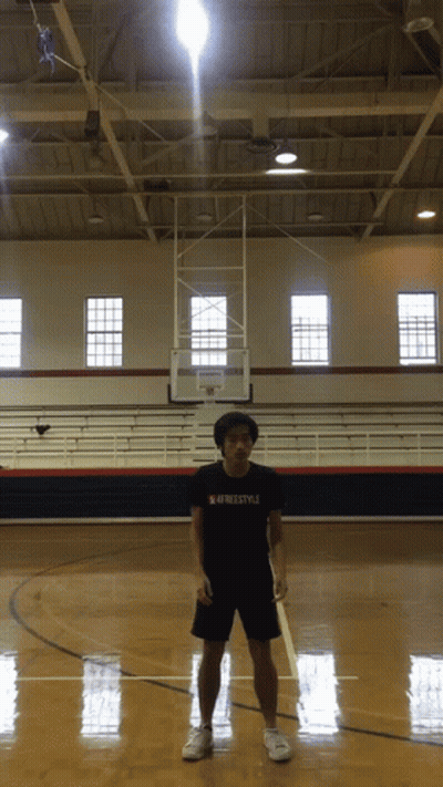 A Man Standing On A Basketball Court Wearing A Freestyle Shirt GIF
