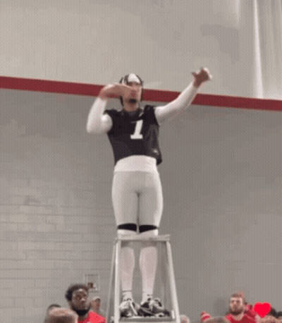 A Man Standing On A Ladder With The Number 7 On His Jersey GIF