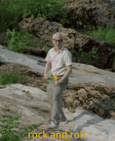 A Man Standing On A Rock With The Words Rock And Roll Written Below Him GIF