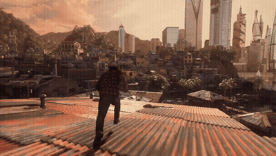 A Man Standing On A Rooftop Looking Out Over A City GIF
