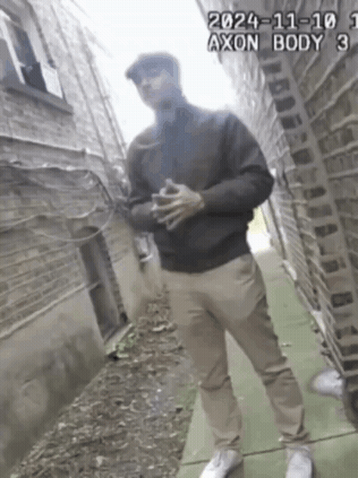 A Man Standing On A Sidewalk With The Date 2024-11-101 GIF