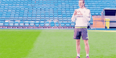 A Man Standing On A Soccer Field Wearing A Shirt That Says Emirates On It GIF