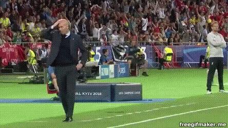 A Man Standing On A Soccer Field With His Hands On His Head . GIF