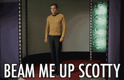 A Man Standing On A Stage With The Words Beam Me Up Scotty On The Bottom GIF