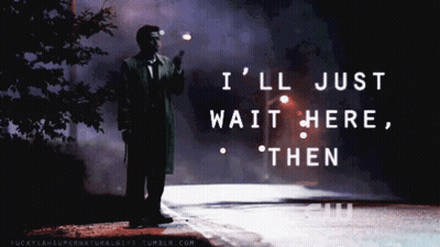 A Man Standing On The Side Of A Road With The Words " I 'Ll Just Wait Here Then " On The Bottom GIF