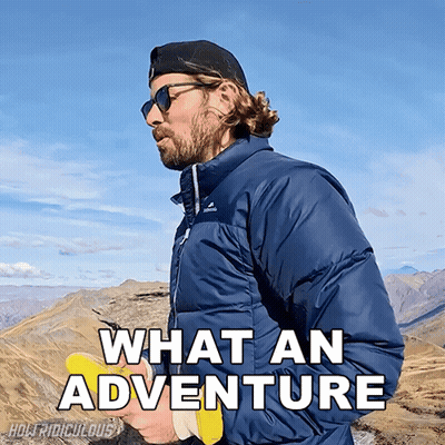 A Man Standing On Top Of A Mountain With The Words What An Adventure Written Below Him GIF