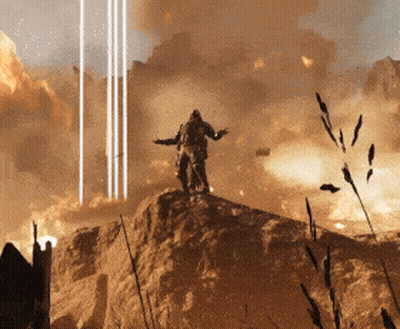 A Man Standing On Top Of A Rock With His Arms Outstretched In Front Of An Explosion GIF
