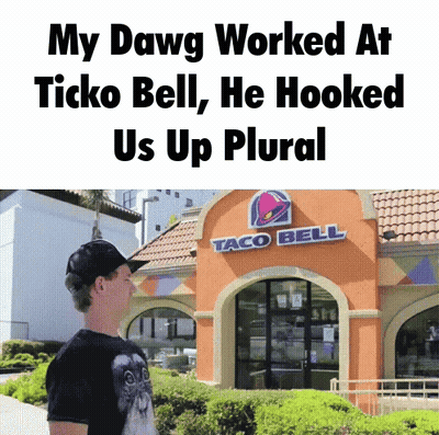 A Man Standing Outside Of A Taco Bell Restaurant GIF