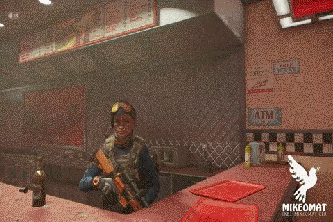 A Man Stands At A Counter In A Restaurant With A Sign That Says Atm On It GIF