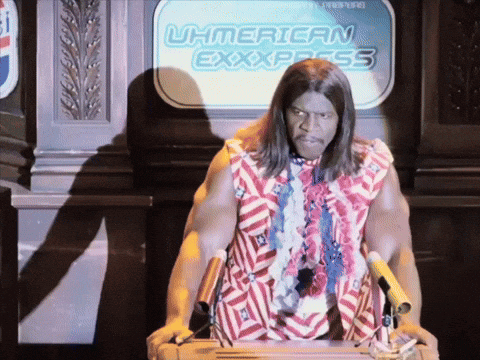A Man Stands At A Podium In Front Of A Sign That Says U.h.american Express GIF