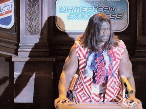 A Man Stands At A Podium In Front Of A Sign That Says Uh American Express GIF