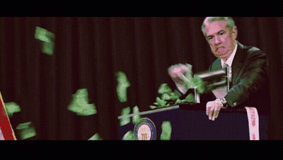 A Man Stands At A Podium While Money Falls From The Sky GIF