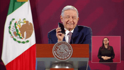 A Man Stands At A Podium With A Seal That Says Mexicanos Unidos Mexicanos GIF