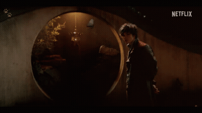A Man Stands In A Dark Room With A Netflix Logo On The Bottom GIF
