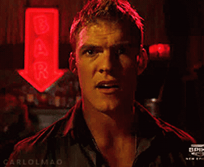 A Man Stands In Front Of A Bar Sign GIF