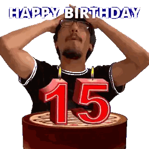 A Man Stands In Front Of A Birthday Cake With Candles In The Shape Of The Number 15 Sticker
