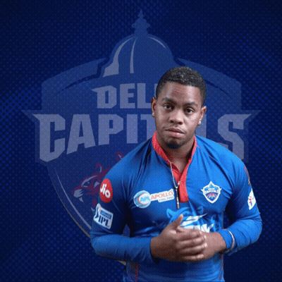 A Man Stands In Front Of A Blue Background With The Word Del Capitals On It GIF