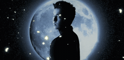 A Man Stands In Front Of A Blue Full Moon GIF