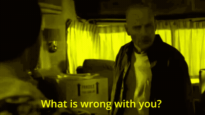 A Man Stands In Front Of A Box That Says Fragile GIF