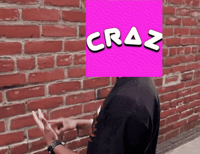 A Man Stands In Front Of A Brick Wall With A Pink Square With The Word Craz Written On It GIF