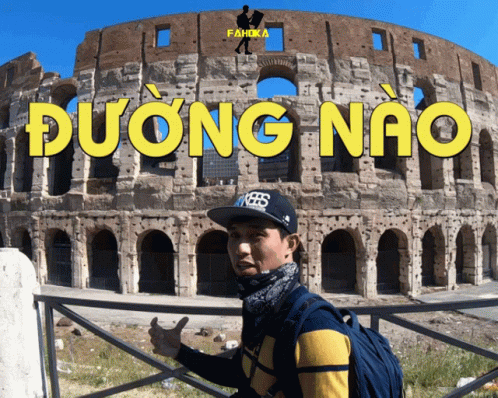 A Man Stands In Front Of A Building That Says " Dương Nao " On It GIF