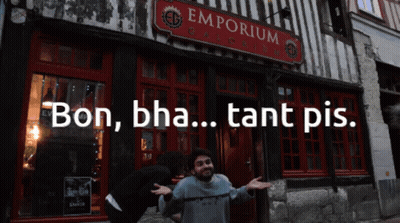 A Man Stands In Front Of A Building That Says Emporium On It GIF