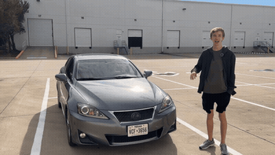 A Man Stands In Front Of A Car With A Texas License Plate That Says Ycf-3656 GIF