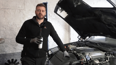 A Man Stands In Front Of A Car With Its Hood Open GIF