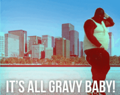 A Man Stands In Front Of A City Skyline With The Words It 'S All Gravy Baby Below Him GIF