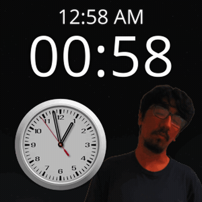 A Man Stands In Front Of A Clock That Says 12:58 Am On It GIF