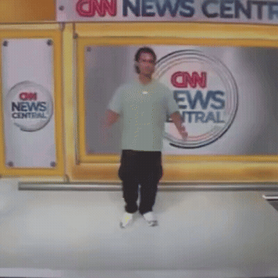 A Man Stands In Front Of A Cnn News Central Sign GIF