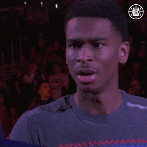 A Man Stands In Front Of A Crowd Wearing A Nba Logo GIF
