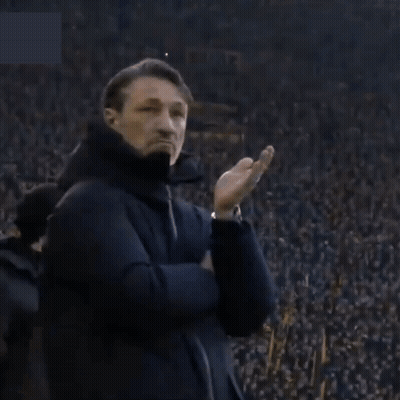 A Man Stands In Front Of A Crowd With A Sign That Says ' Allianz ' GIF