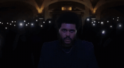 A Man Stands In Front Of A Crowd With A Sticker On His Forehead That Says I Love You GIF