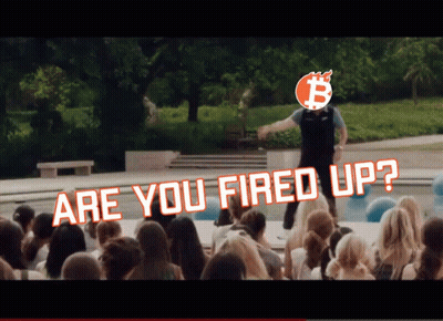 A Man Stands In Front Of A Crowd With The Words " Are You Fired Up " Above Him GIF