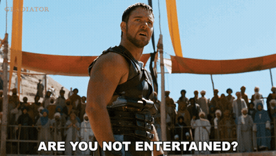 A Man Stands In Front Of A Crowd With The Words Are You Not Entertained GIF