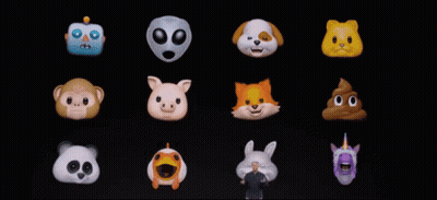 A Man Stands In Front Of A Display Of Cartoon Faces GIF