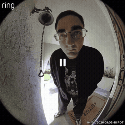 A Man Stands In Front Of A Door With A Welcome Mat GIF