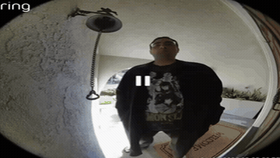 A Man Stands In Front Of A Door With A Welcome Mat GIF
