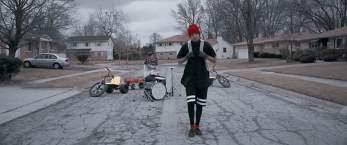 A Man Stands In Front Of A Drum Set That Says Twenty One Pilots On It GIF