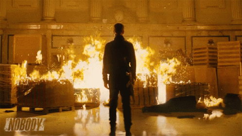 A Man Stands In Front Of A Fire With The Words Nobody 'S On The Bottom Right GIF