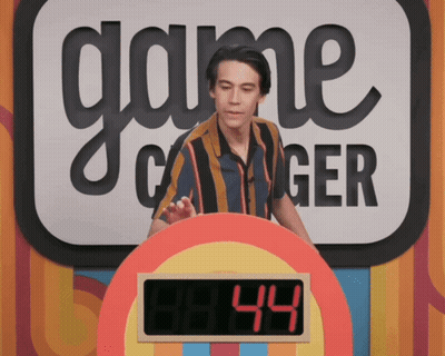 A Man Stands In Front Of A Game Called Game Changer GIF