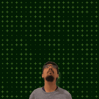A Man Stands In Front Of A Green Background With The Number 11 + 15 On It GIF