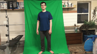 A Man Stands In Front Of A Green Screen GIF