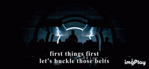 A Man Stands In Front Of A Group Of People With The Words First Things First Let 'S Buckle Those Belts GIF