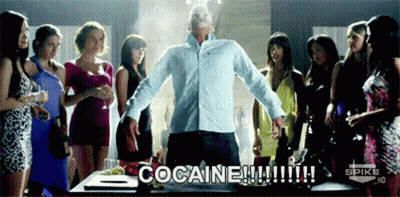 A Man Stands In Front Of A Group Of Women With The Words Cocaine Written On The Screen GIF