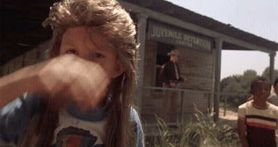 A Man Stands In Front Of A Juvenile Detention Center Building GIF