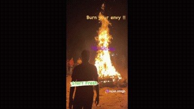a man stands in front of a large fire with the words burn your envy on it