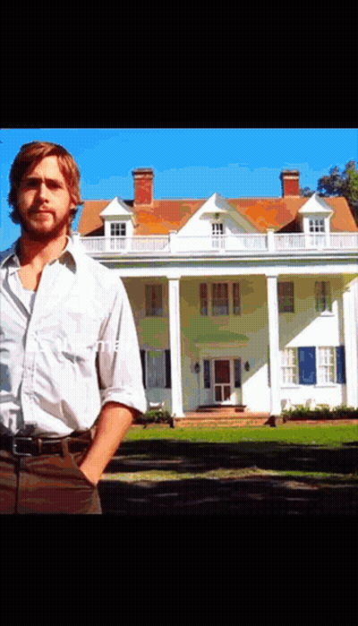 A Man Stands In Front Of A Large White House With His Hands In His Pockets GIF