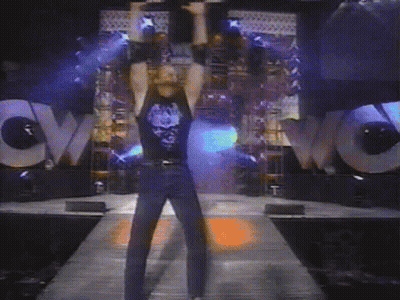 A Man Stands In Front Of A Large Wow Sign GIF